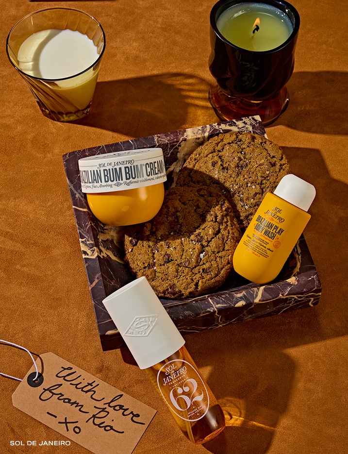 Variety of beauty products next alongside a plate of cookies.